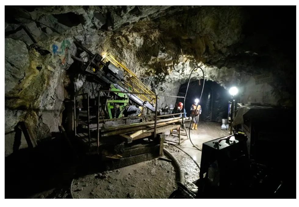 U92 Energy industrial machinery is surrounded by rocky walls and workers in protective gear illuminate the scene.
