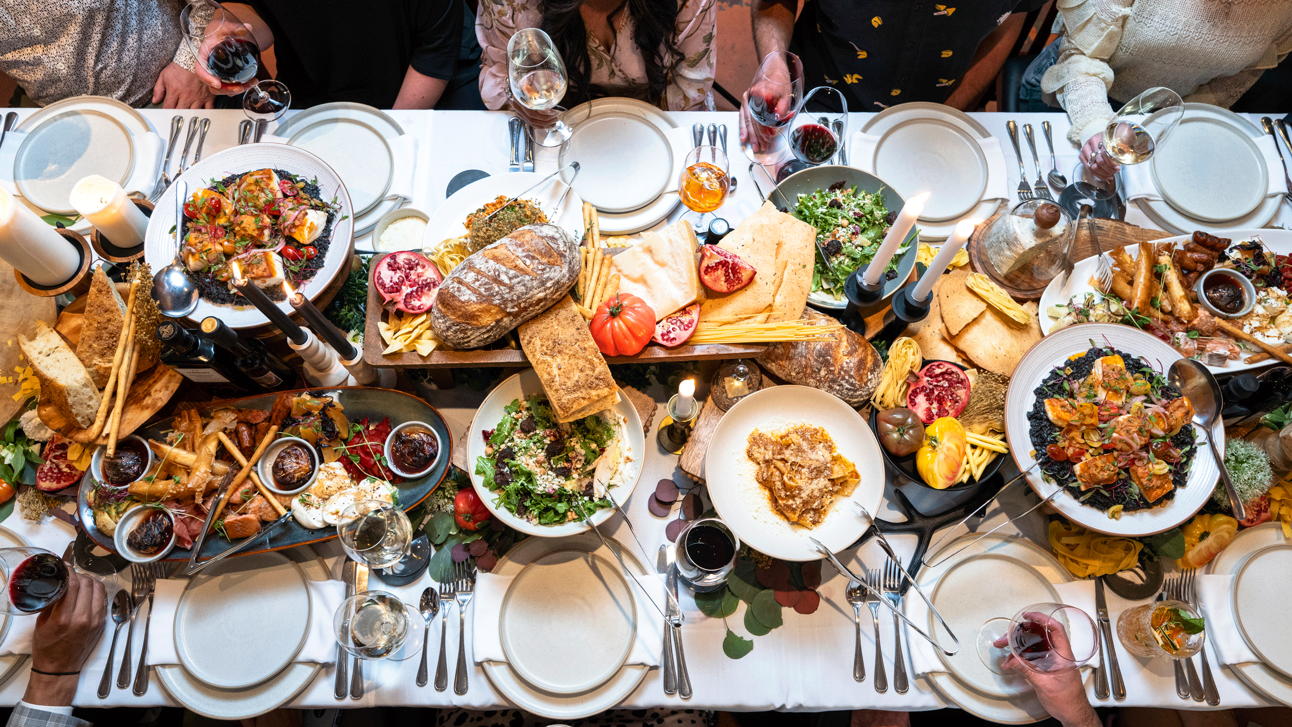 Celebration table laden with food and wine