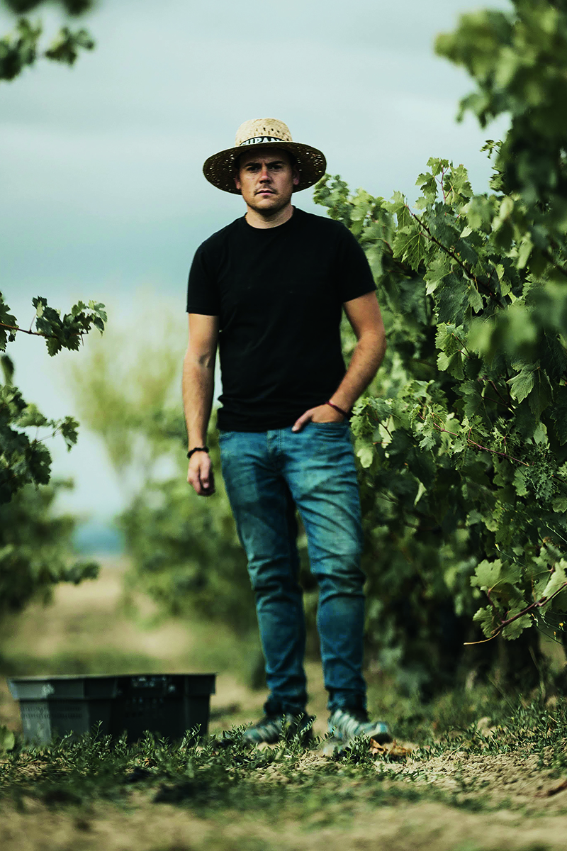 Miguel Eguíluz standing in vineyard