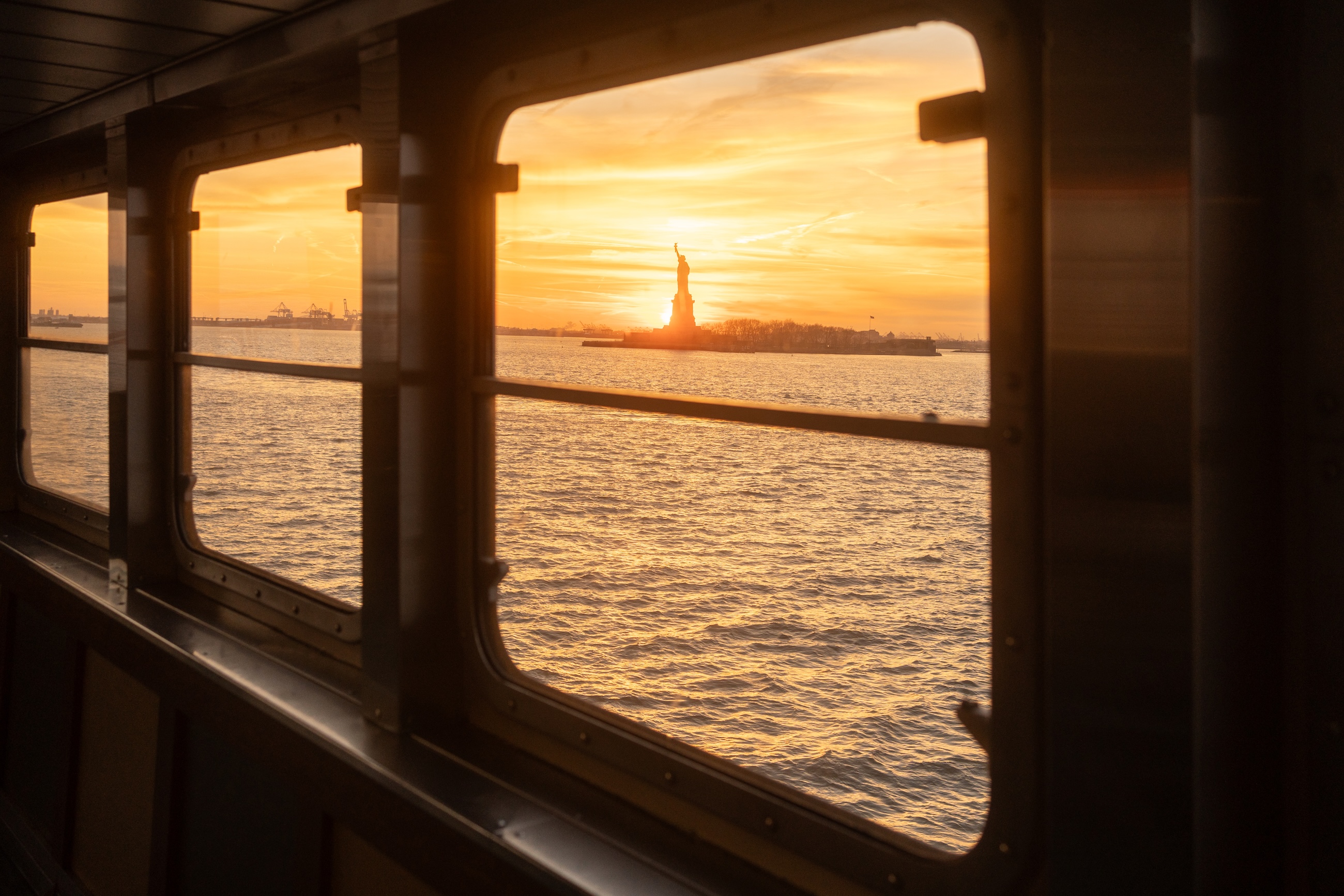 statue of liberty seen through ferry window