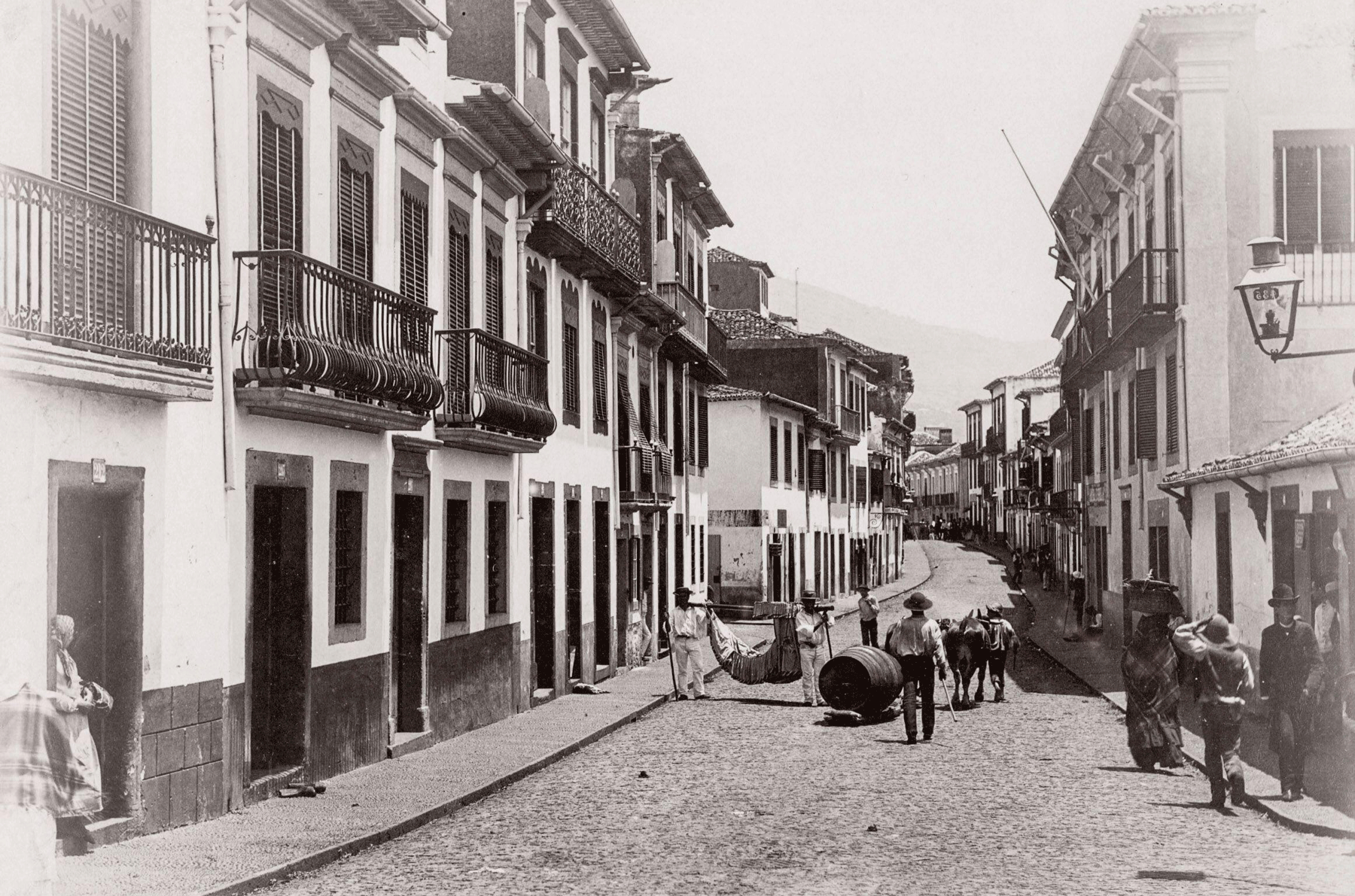 19th century street scene in Funchal, Madeira, Portugal with carrying chair and wine barrel